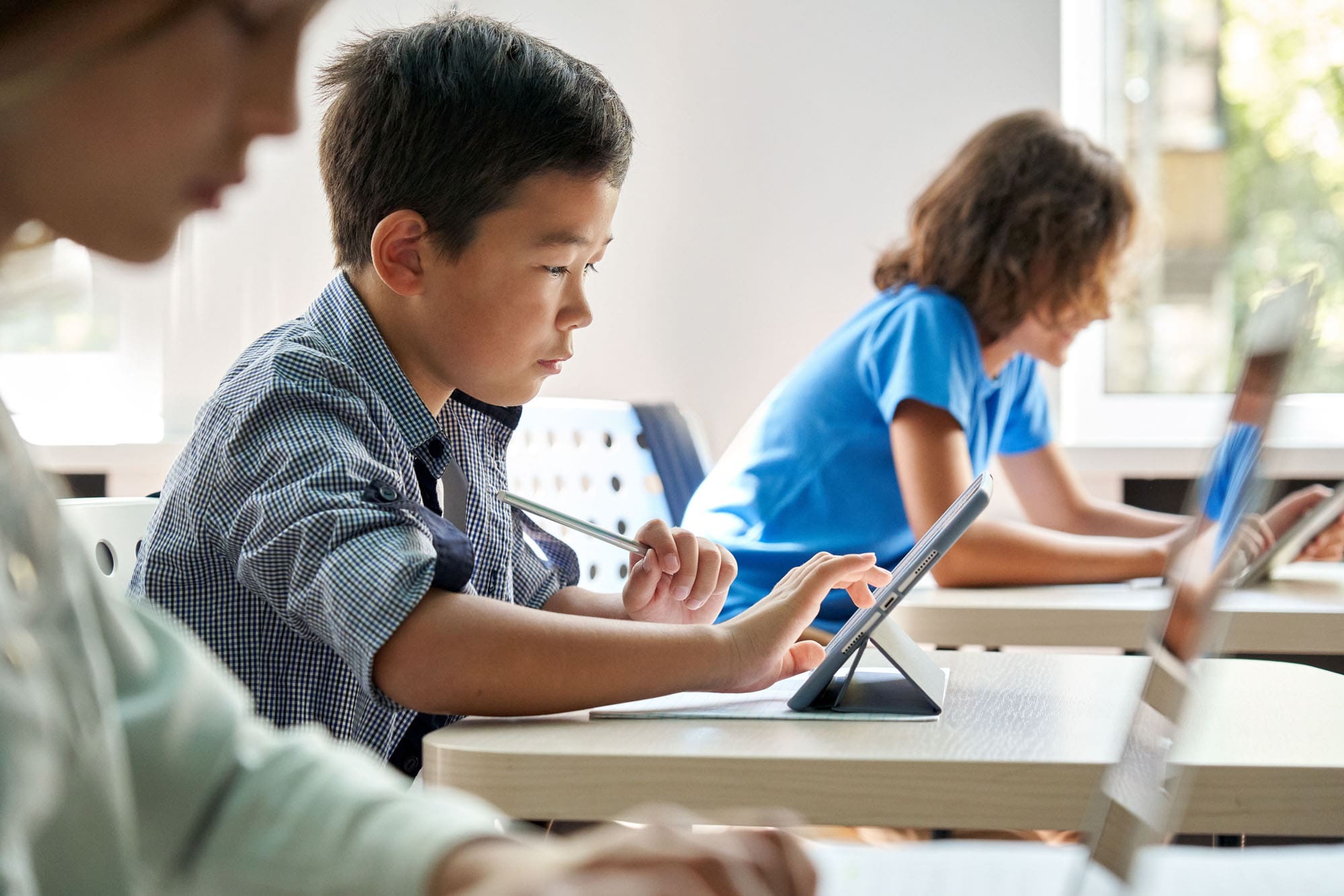 Child in school on a tablet.